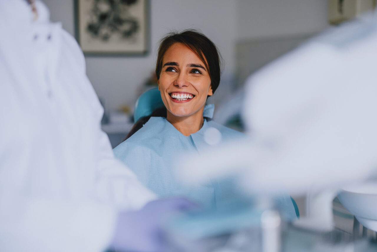 Smiling Woman At Dentist Office During Dental Checkup