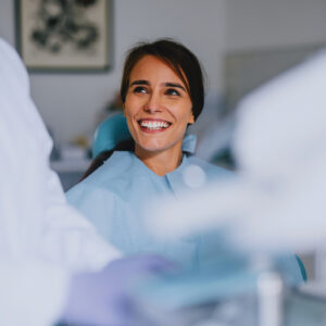 Smiling Woman At Dentist Office During Dental Checkup